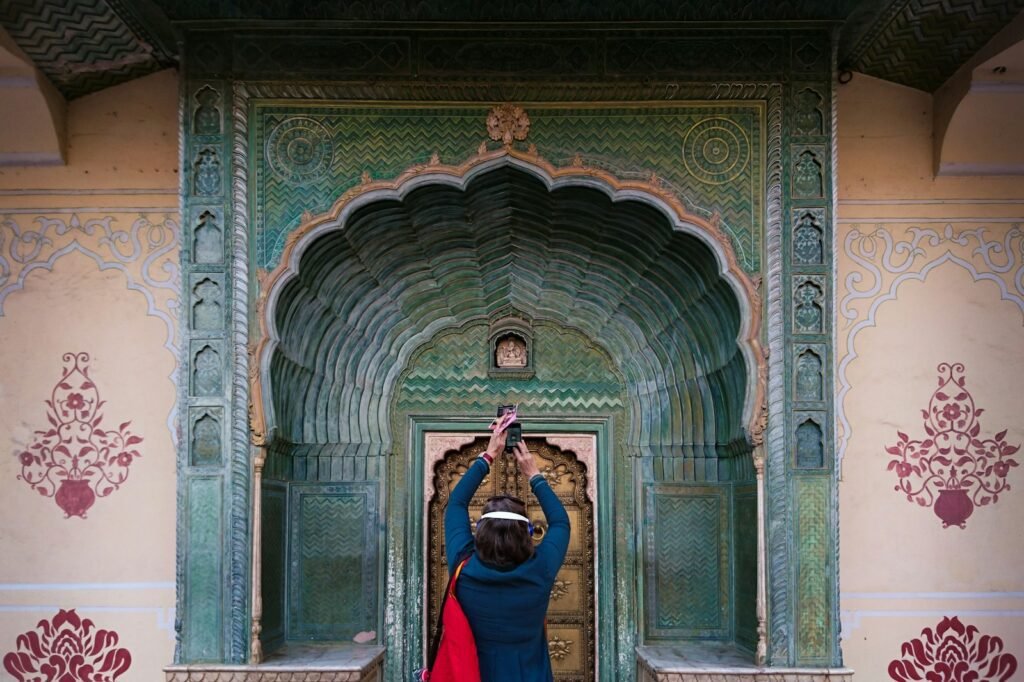 a woman taking a picture of a woman in a blue dress